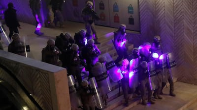 Special forces police are illuminated by laser pointers from anti-government protesters. AP Photo