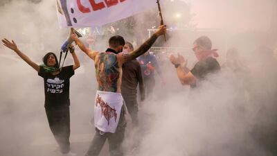 Protesters shout slogans during a demonstration against Israeli Prime Minister Benjamin Netanyahu's alleged corruption, the postponement of his trial and his handling of the coronavirus crisis, outside his residency in Jerusalem. Reuters