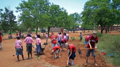 School pupils help out in a community project at Camp Tsavo in Kenya. Courtesy Camps International