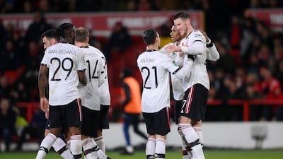 Wout Weghorst celebrates with teammates after scoring United's second goal. Getty