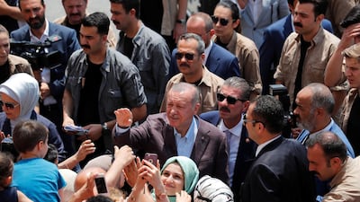 Turkish President Tayyip Erdogan greets people after casting his ballot, outside a polling station in Istanbul, Turkey, June 23, 2019. Murad Sezer / Reuters