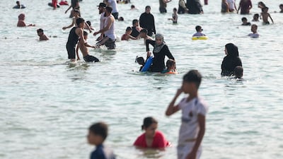 Syrians gather at a beach in the coastal city of Latakia. The country's government has issued directives that say people should wear modest clothing at beaches and swimming pools. AFP
