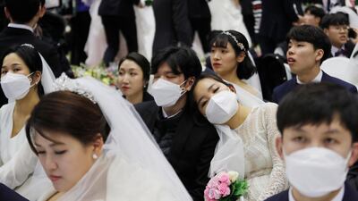 A couple takes a nap before a mass wedding ceremony at the Cheong Shim Peace World Center in Gapyeong, South Korea. AP Photo