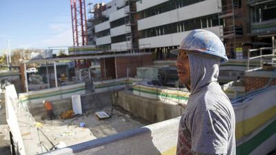 A worker looks over a construction site of a residential block in the Valdebebas neighbourhood. Andrea Comas / Reuters