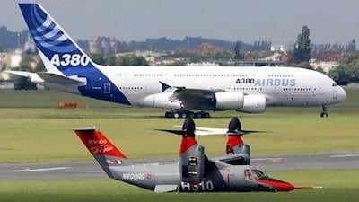 A vertical takeoff and landing aircraft, the BA 09 tilt rotor, runs on the taxiway in font of an Airbus A380 after a training session. REUTERS/Pascal Rossignol (FRANCE)