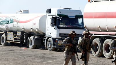 Saudi soldiers walk by oil tanker trucks delivered by Saudi authorities to support charities and NGOs in Marib, Yemen. Reuters