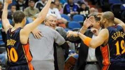 Warriors players congratulate their coach Don Nelson, centre, after beating Minnesota.