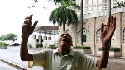 Girdhar Peshawaria, president of the Gateway of India laughter club, leads members during a morning laughter session.