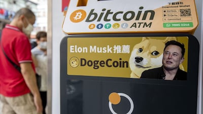 A sticker advertising Dogecoin on a cryptocurrency automated teller machine at a laundromat in Hong Kong. Bloomberg