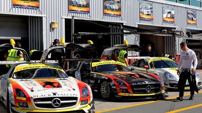 The Team Abu Dhabi by Black Falcon staff get their cars ready before the start of the first practice session. Satish Kumar / The National