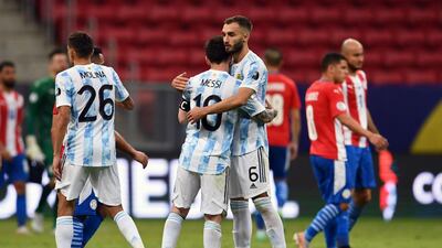 Lionel Messi and German Pezzella hug at the end of the match. AFP