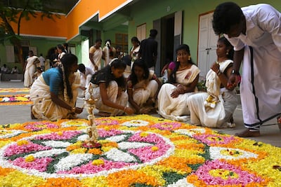 Children prepare a floral rangoli, a decorative design made on the occasion of festivals, as part of the Onam festival celebrations at a school in Chennai in August. AFP