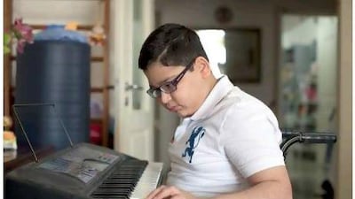 Pulkit Chopra, 11, plays the piano at home. He has cerebral palsy but has just graduated Grade 5 at the Gems Millenium School. Millennium