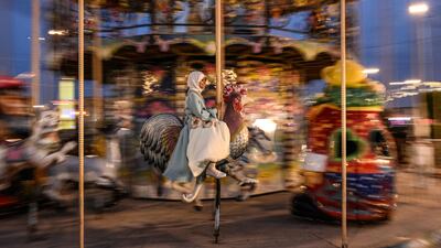 A girl celebrates Eid on a merry-go-round in Basra, Iraq. AFP