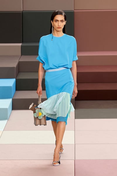 A sleek turquoise skirt at Fendi is softened with a piece of sheer blue fabric. Photo: Fendi