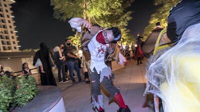 Halloween performers dance and scare the visitors to the Town Square Halloween event.