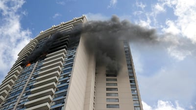Smoke billows from the upper floors of the Marco Polo apartment complex in Honolulu. Marco Garcia / AP Photo