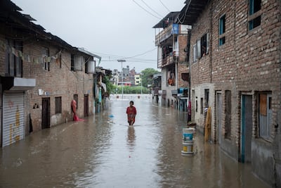 A person wades through a flooded street after torrential rains in Kathmandu, Nepal, July 6, 2024. EPA