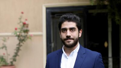 Abdullah Morsi, the youngest son of Egypt's jailed former Islamist President Mohamed Morsi, poses for a photograph in front of his home in Cairo, Egypt. AP