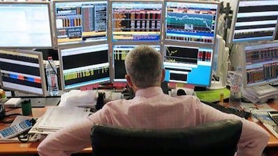 Hard to see the forest for the screens: a broker tracks shares on multiple computers. Taking a long-term view of your stock portfolio is one way to survive market turbulence. Eric Piermont / AFP