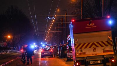 Policemen form a security perimeter as firefighters battle to put out a blaze in a building in Vaulx-en-Velin, France. AFP