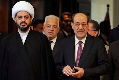 Qais Al Khazali, left, head of Asaib Ahl al-Haq, stands alongside former Iraqi prime minister Nouri Al Maliki, right, after voting in Iraq's parliamentary elections. AFP