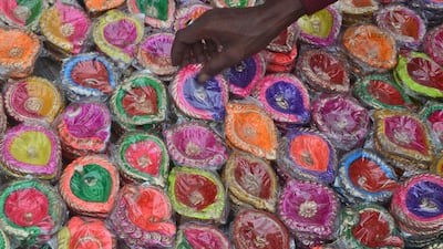 A vendor arranges designer lamps in a market on the eve of Diwali in Guwahati, India. EPA