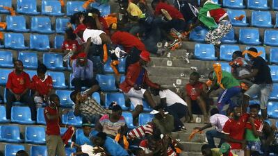 Equatorial Guinea fans react as a police helicopter hovers over after some of them threw objects during their African Nations Cup semi-final soccer match against Ghana in Malabo February 5, 2015. Violent scenes overshadowed the African Nations Cup semi-final as Ghana reached Sunday?s final with a 3-0 win over hosts Equatorial Guinea on Thursday in a match halted for 34 minutes late in the second half. REUTERS/Amr Abdallah Dalsh