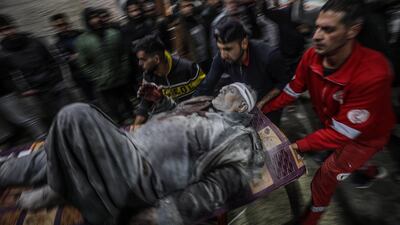 Medics move a man injured in an Israeli attack on Deir Al Balah refugee camp, in central Gaza. EPA