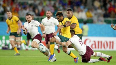Will Genia of Australia kicks as he is tackled by Georgia's Otari Giorgadze. Getty