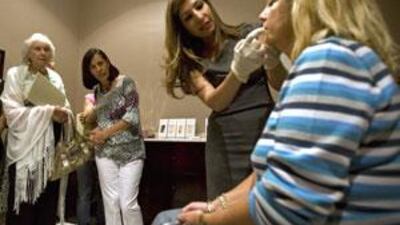 Dr Buthainah al Shunnar, at her clinic in Dubai, analyses the areas of Kasia Sinclair's face she will be applying the filler injections to.