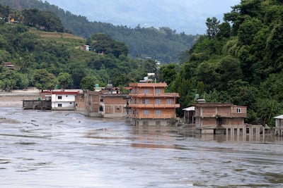 Houses submerged in thick mud following flash floods along the banks of the river in the Dhading district, Nepal. EPA