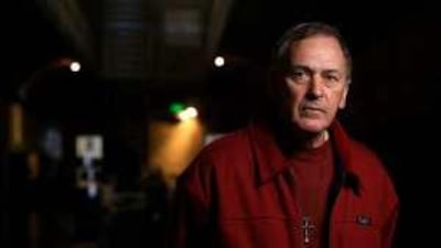 Father Peter Norden, pictured in the Old Melbourne Gaol, is lobbying for tests on the remains to prove they are those of the outlaws.