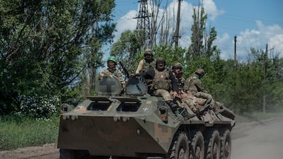 Ukrainian soldiers ride an armoured personnel carrier near Bakhmut in the Donetsk region. Iryna Rybakova via AP