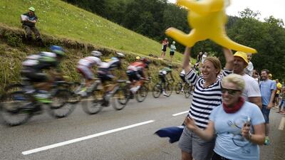 Australian supporters cheer along the road as the peloton ride through the French Alps during the mountainous 18th stage of the Tour de France on Thursday. Lionel Bonaventure / AFP