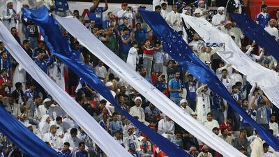 Supporters of Al Nasr celebrate after watching their team win the Arabian Gulf Cup at Rashid Stadium. Pawan Singh / The National