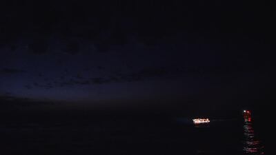 Migrants and refugees seated in a wooden boat wait to be rescued by Maltese NGO MOAS during an operation of rescue ship Topaz Responder, off the Libyan coast in the Mediterranean Sea. Andreas Solaro / AFP