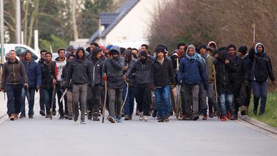 A group of migrants carrying sticks during clashes near the ferry port in Calais, northern France on February 1. EPA/JOHAN BEN AZZOUZ