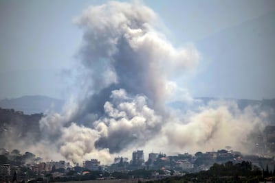 Smoke rises from the site of an explosion carried out by the Israeli military in the village of Kfar Tibnit, as seen from Zawtar Al Gharbiyeh. AFP