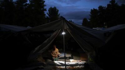A Syrian man sits inside his tents at Ritsona refugee camp north of Athens, which hosts about 600 refugees and migrants. Petros Giannakouris / AP Photo