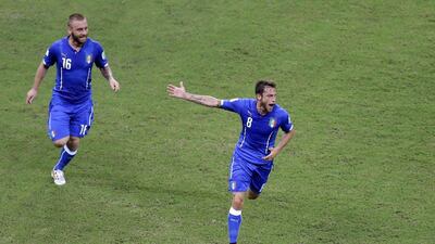 Claudio Marchisio, chased by Daniele De Rossi, celebrates his opening goal against England at the 2014 World Cup on Saturday in Manaus, Brazil. Themba Hadebe / AP