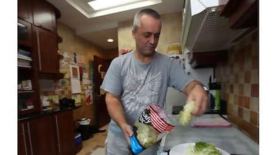 Doug Macaskill prepares his dinner at his home in Abu Dhabi, but he says he would rather put pins in his eyes than cook.