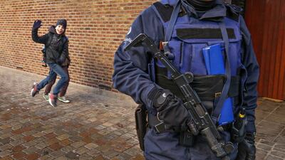 A Belgian police officer stands guard outside a school in central Brussels. Yves Herman / Reuters