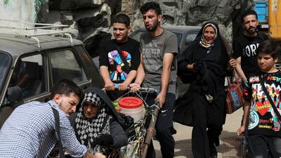 People evacuate the village after flash floods. Heavy rains in the early hours of Thursday caused floods and then landslides and damaged Emamzadeh Davoud, a religious shrine. AP Photo