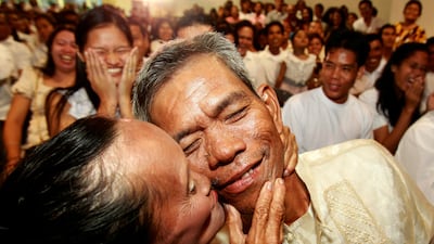 Newly married couple Nonilon and Concepcion Elizalde kiss following a mass wedding sponsored by the city of Paranaque, south of Manila, Philippines on Valentine's Day Tuesday, Feb. 14, 2012. More than 300 couples, all residents of the city, tied the knot ???