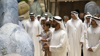 Sheikh Mohammed bin Zayed holds his granddaughter, Sheikha Salama bint Diab, at the opening of Warner Bros World Abu Dhabi. Seen with Sheikh Hamdan bin Mohammed, Crown Prince of Dubai, and Khaldoon Al Mubarak, CEO and Managing Director Mubadala, Chairman of the Abu Dhabi Executive Affairs Authority and Abu Dhabi Executive Council Member (back). Eissa Al Hammadi for The Crown Prince Court