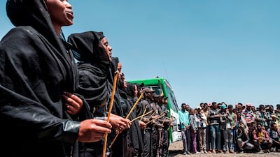 A group of men and women sing during a memorial ceremony at the crash site of the Ethiopian Airlines Flight 302 airplane accident in Tulu Fara, Ethiopia. AFP