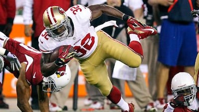 San Francisco 49ers running back Kendall Hunter is tripped up against the Arizona Cardinals