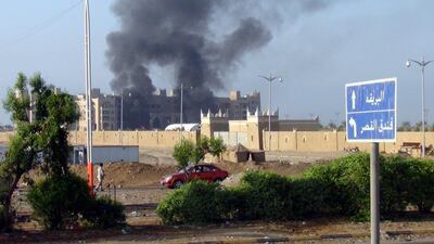 Columns of smoke rise from the Al-Qasr Hotel. Stringer / EPA