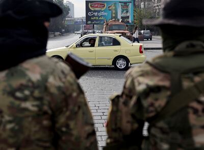 Rebel fighters stand guard at Abbasiyyin Square in Damascus. Reuters
